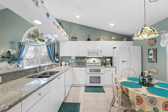 kitchen with white appliances, white cabinets, a sink, and light tile patterned flooring