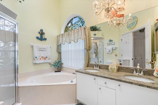 bathroom featuring plenty of natural light, a sink, and a shower stall