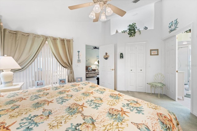 carpeted bedroom with ceiling fan and a high ceiling