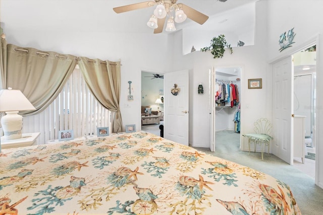 bedroom featuring carpet, a spacious closet, a high ceiling, and a closet