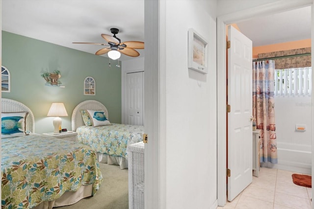 tiled bedroom featuring a ceiling fan