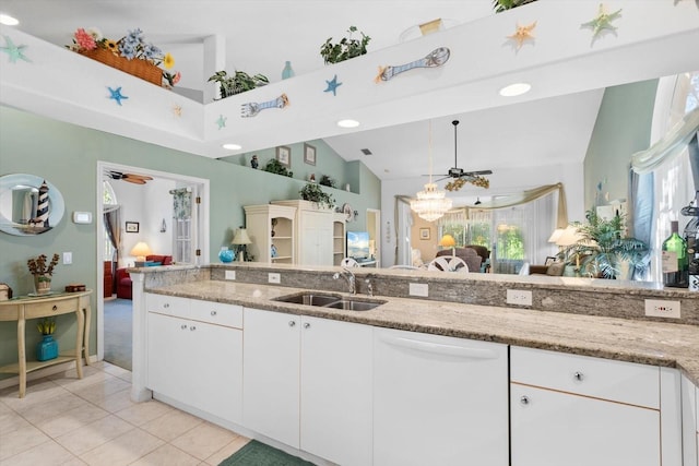 kitchen with light stone countertops, white dishwasher, a ceiling fan, and a sink