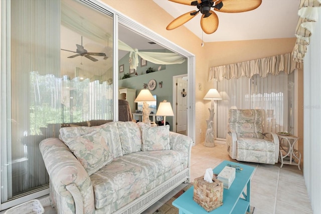 tiled living area with lofted ceiling and ceiling fan