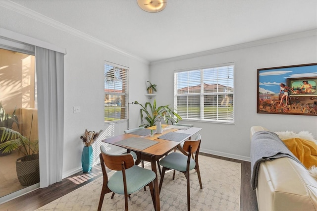 dining area featuring crown molding and hardwood / wood-style floors