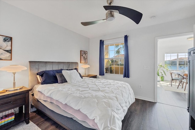 bedroom featuring multiple windows, ceiling fan, and dark hardwood / wood-style floors