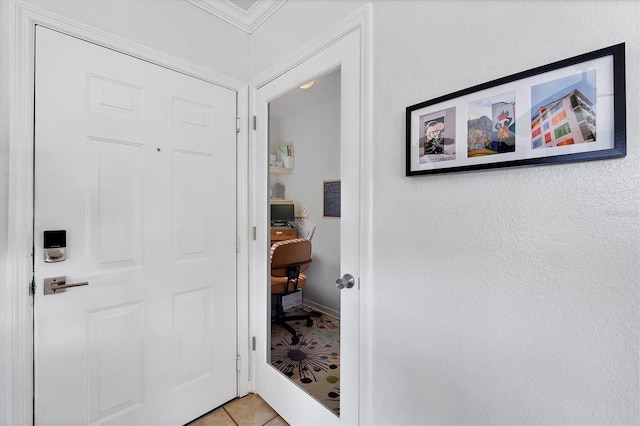 interior space featuring crown molding and light tile patterned floors