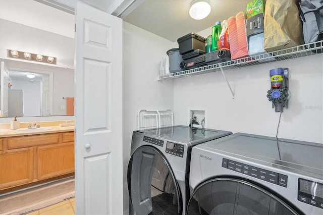 laundry room with separate washer and dryer and sink