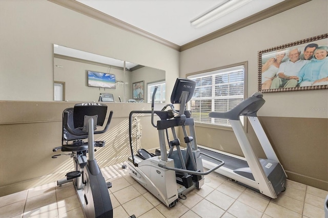 workout room with crown molding and light tile patterned floors