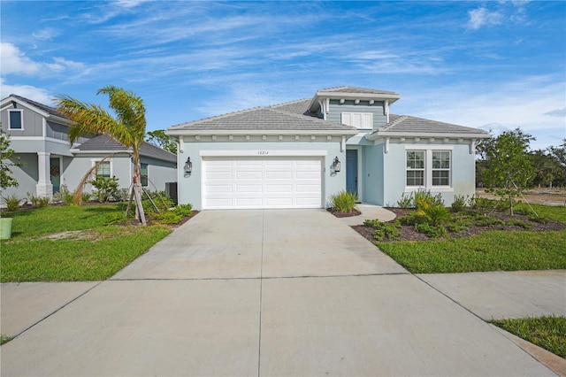 view of front of property featuring central air condition unit, a front lawn, and a garage