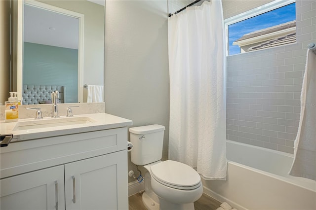 full bathroom featuring hardwood / wood-style floors, vanity, toilet, and shower / tub combo