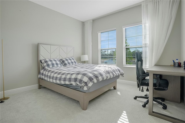 bedroom featuring light carpet