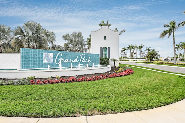 community / neighborhood sign featuring a lawn