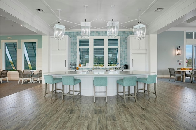 kitchen featuring pendant lighting, white cabinetry, and a large island