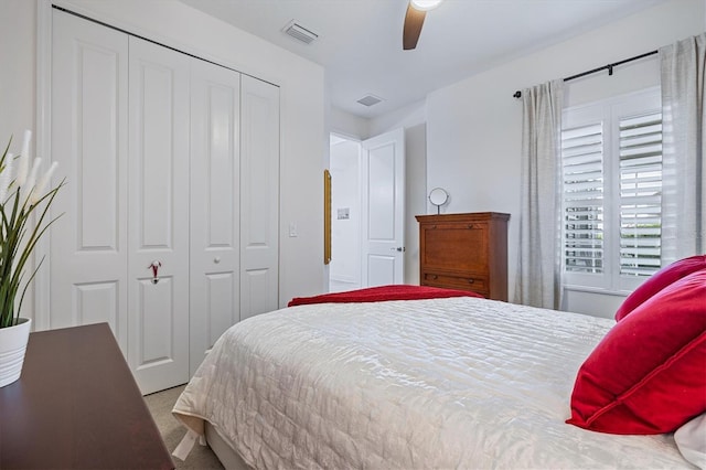 bedroom with ceiling fan, a closet, and carpet