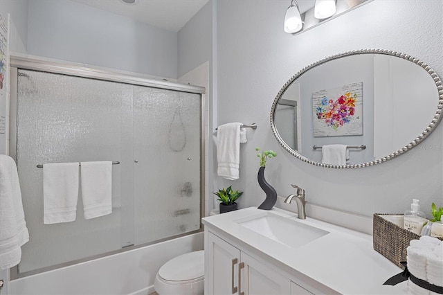 full bathroom with vanity, toilet, and bath / shower combo with glass door