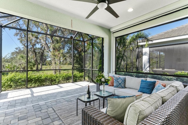 sunroom featuring ceiling fan