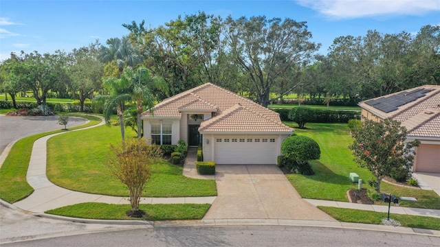 mediterranean / spanish-style home featuring a front yard and a garage