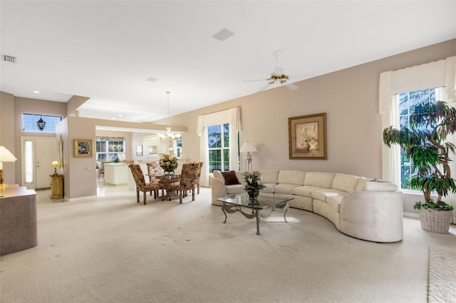 living room with light carpet, plenty of natural light, and ceiling fan