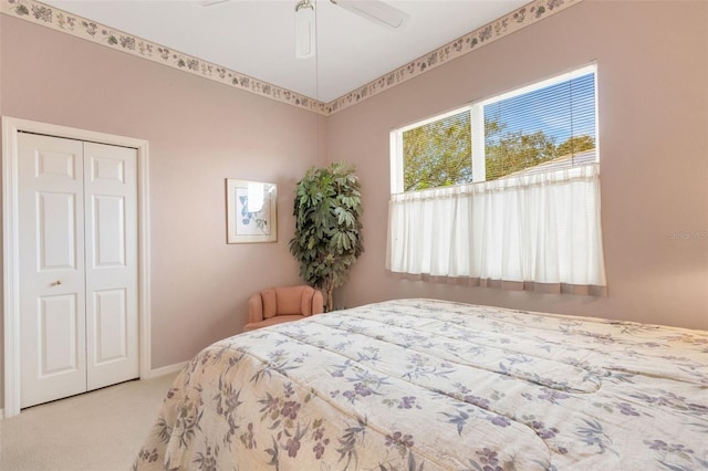 bedroom with light carpet, a closet, and ceiling fan