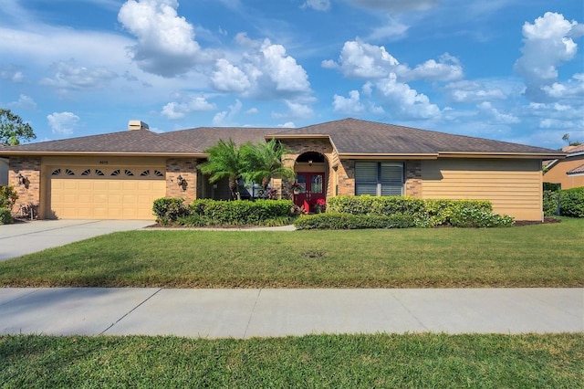 ranch-style house featuring a garage and a front lawn