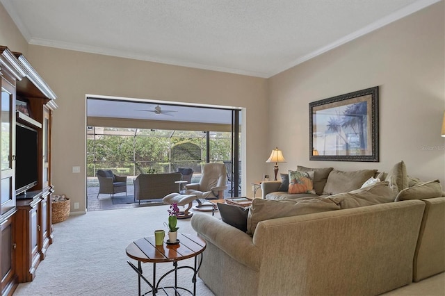 living room with crown molding, ceiling fan, light colored carpet, and a textured ceiling