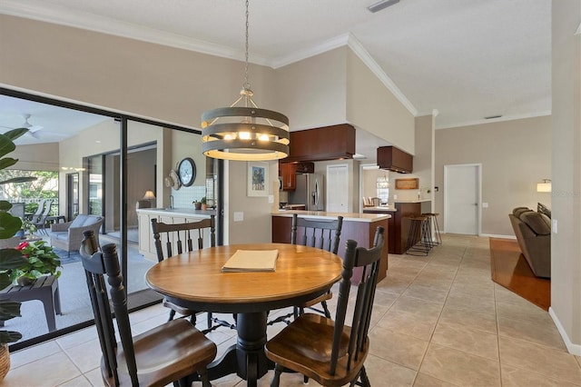 dining space featuring ceiling fan with notable chandelier, light tile patterned flooring, and ornamental molding