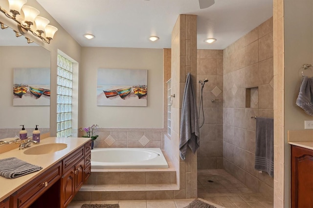 bathroom with tile patterned flooring, vanity, and independent shower and bath