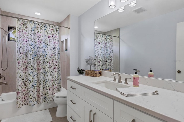 full bathroom featuring tile patterned flooring, vanity, toilet, and shower / tub combo