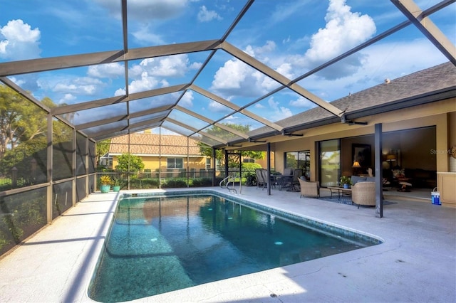 view of pool featuring glass enclosure and a patio