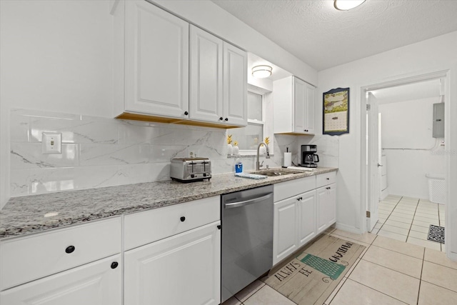 kitchen featuring stainless steel dishwasher, sink, white cabinets, and a textured ceiling