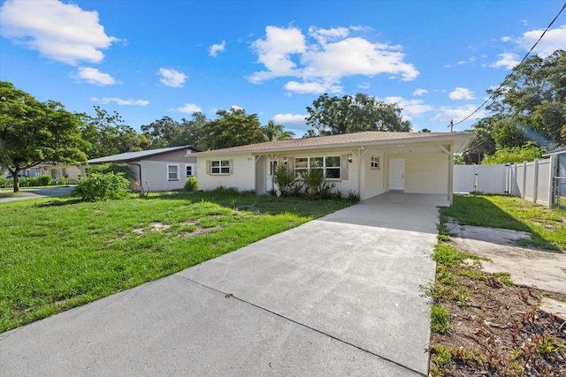 ranch-style home featuring a front yard and a carport