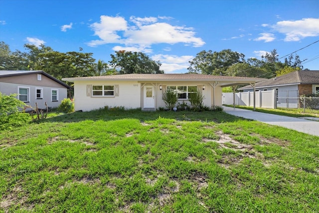 ranch-style home featuring a front yard and a carport