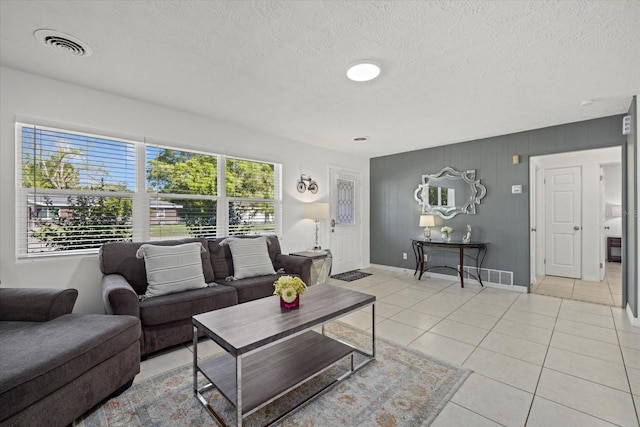 living room featuring light tile patterned floors and a textured ceiling