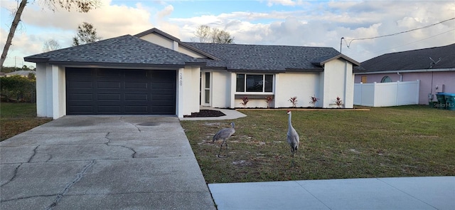 ranch-style home featuring a garage and a front lawn