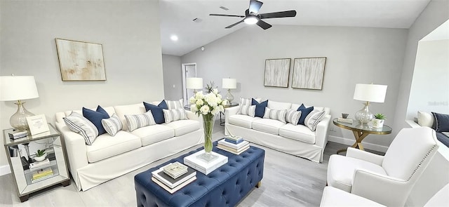 living area with vaulted ceiling, wood finished floors, baseboards, and ceiling fan