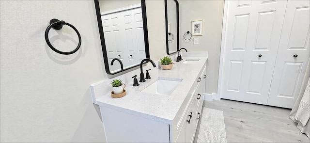 bathroom featuring double vanity and a sink