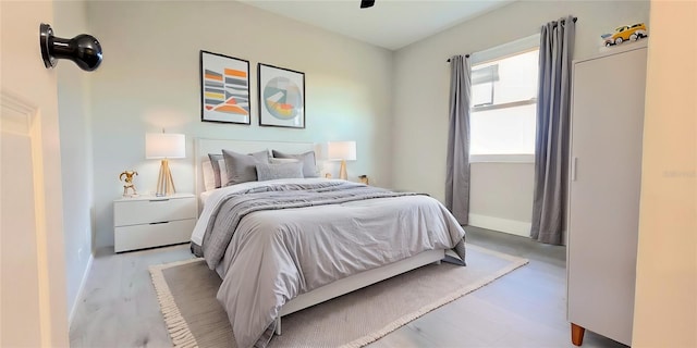 bedroom featuring wood finished floors and baseboards