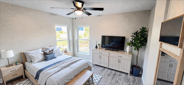 bedroom featuring light wood-style floors and ceiling fan