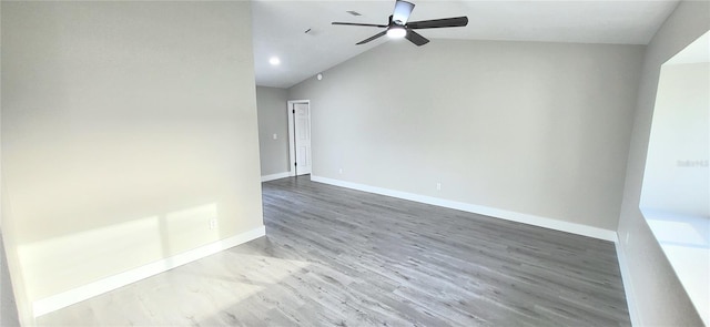 unfurnished room with vaulted ceiling, ceiling fan, baseboards, and wood finished floors