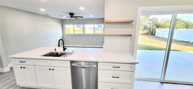 kitchen featuring light wood-type flooring, a sink, open shelves, white cabinetry, and light countertops