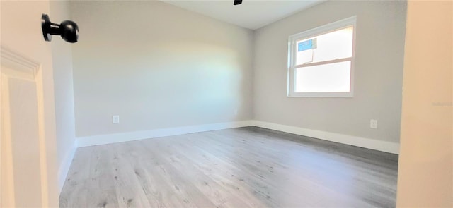 unfurnished room featuring wood finished floors and baseboards