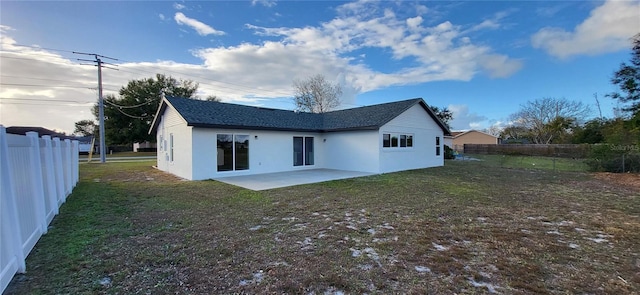 back of house featuring stucco siding, a patio, a lawn, and fence