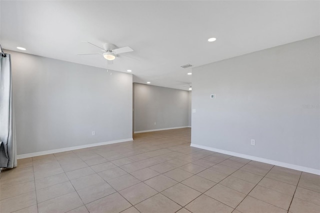 tiled empty room featuring ceiling fan