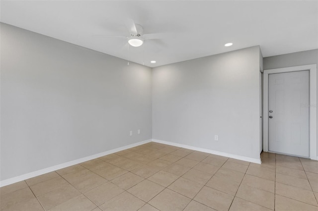 spare room featuring ceiling fan and light tile patterned floors