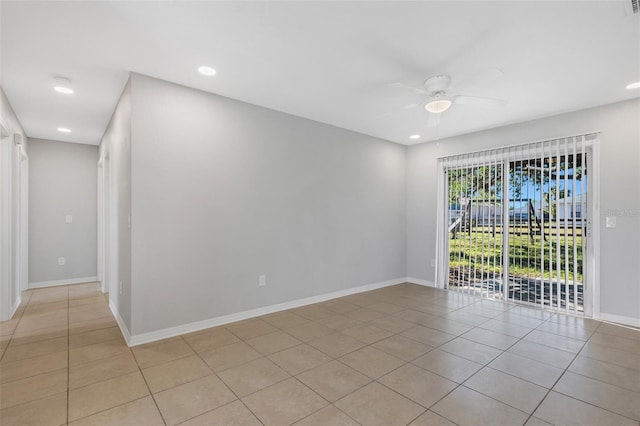 unfurnished room with ceiling fan and light tile patterned flooring