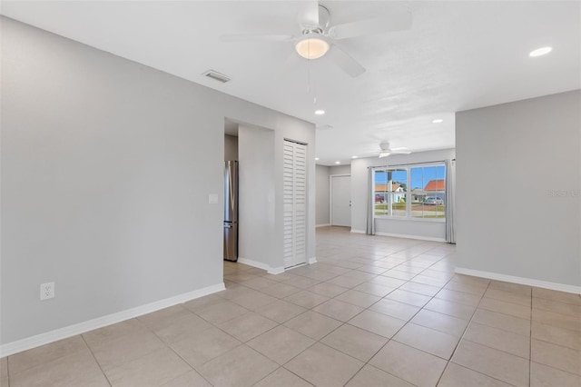 tiled empty room with ceiling fan