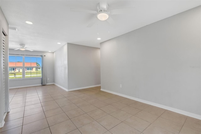 spare room with ceiling fan and light tile patterned floors