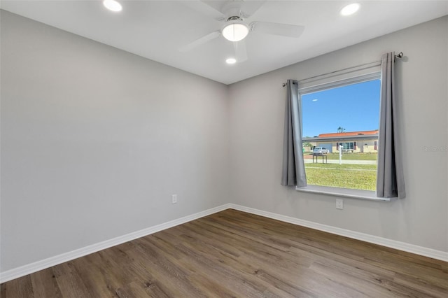 spare room with hardwood / wood-style flooring and ceiling fan