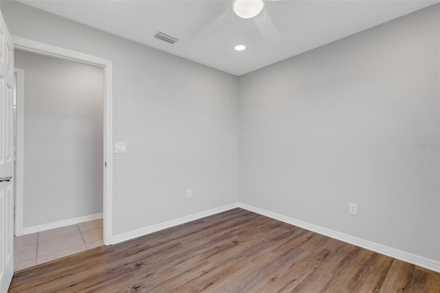 spare room featuring hardwood / wood-style floors and ceiling fan