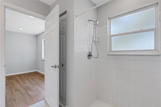 bathroom featuring hardwood / wood-style floors and tiled shower